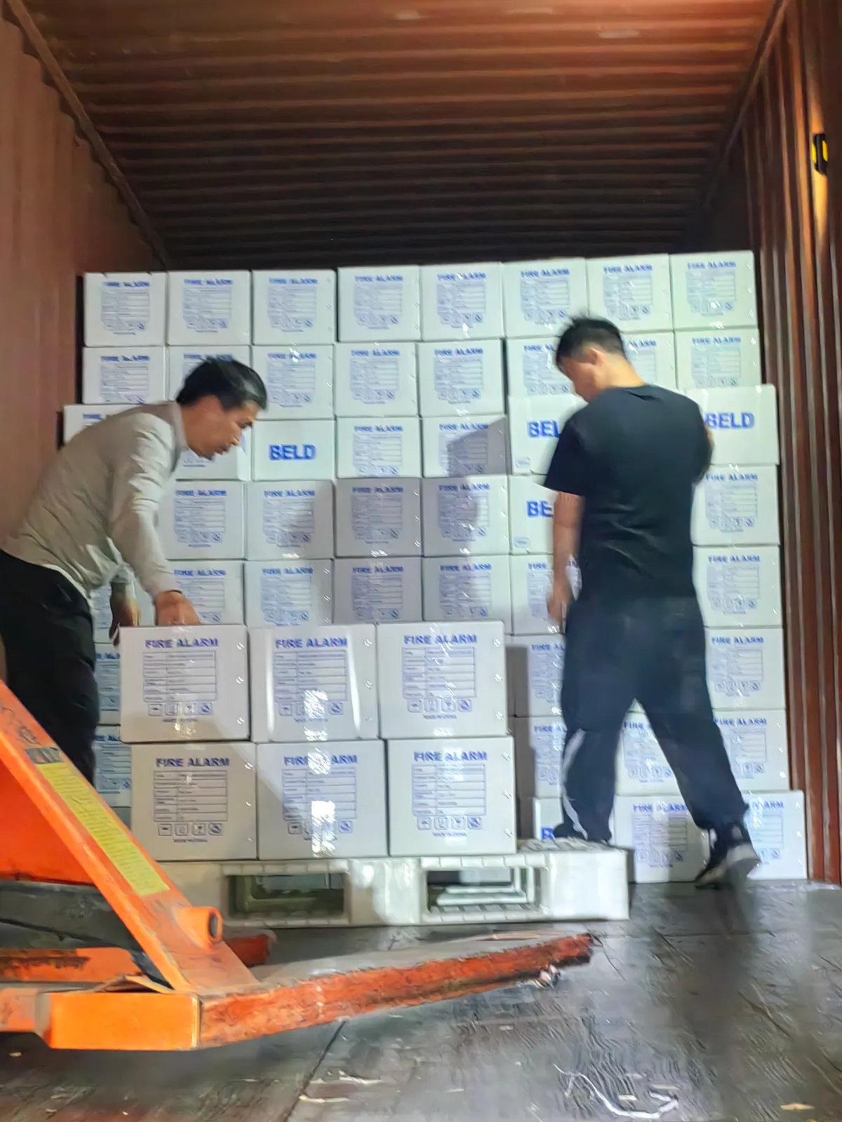 Fig 1: Fire alarm cable drums and coils inside the 40HQ at the port in Ningbo — drums floor-loaded, coils stacked above
