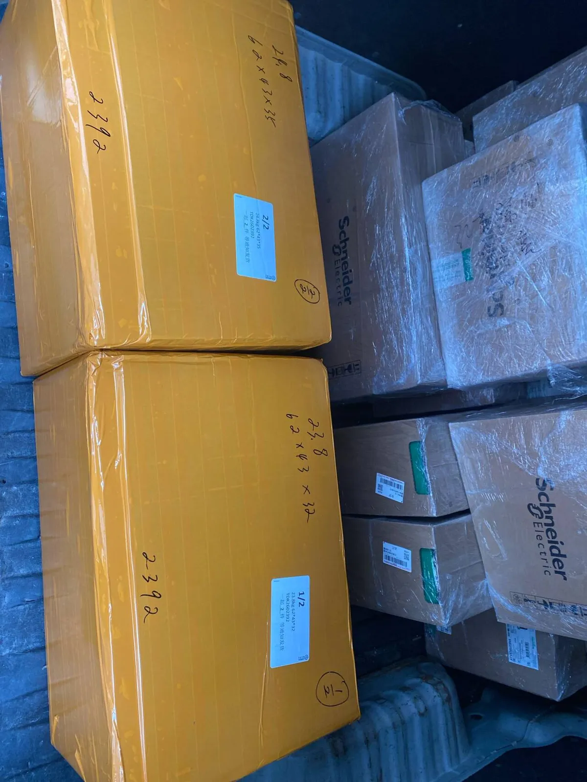 Fig 1: Control module cartons staged at the consolidation point in Guangzhou before air freight palletization — mixed carton sizes visible