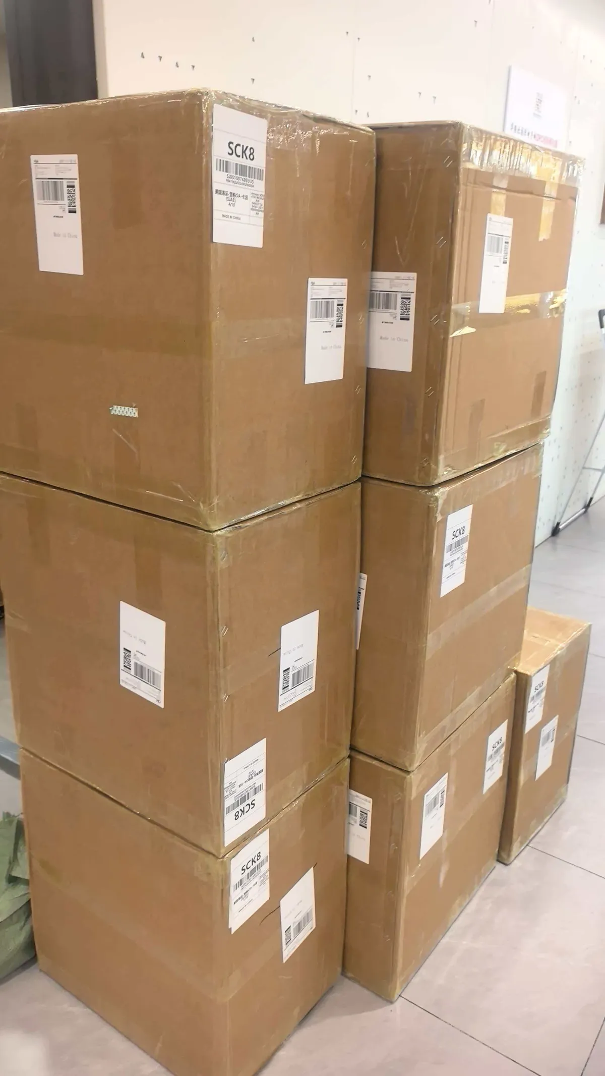 Fig 1: Bicycle seat cartons staged for LCL consolidation at Shenzhen — light cartons banded onto a single pallet to minimize volume