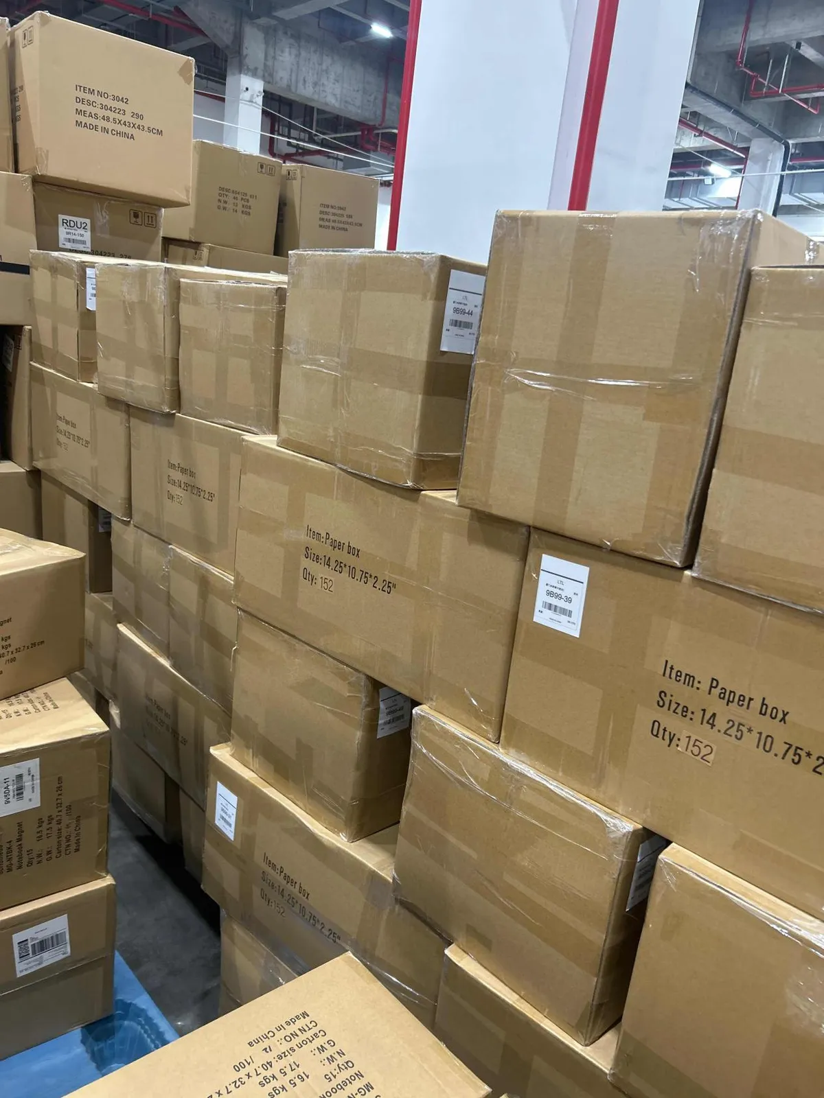 Fig 1: Paper box cartons staged at the Shenzhen consolidation point — paperboard SKUs shrink-wrapped with moisture-barrier film