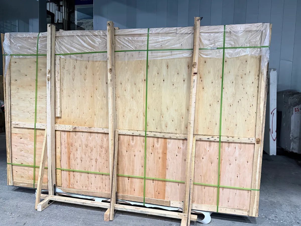 Fig 1: Marble slab crates staged at the Xiamen loading point — timber-framed crates with the polished faces packed inward and vertical loading planned