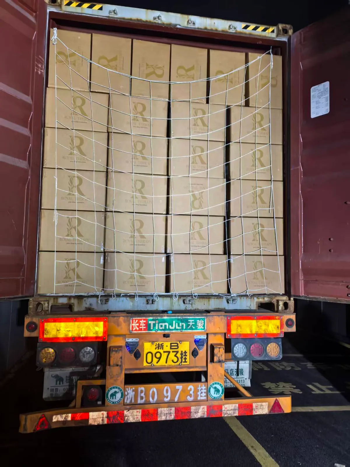 Fig 2: Compressed bales palletized and shrink-wrapped inside the 40HQ — netting applied to hold the soft bales in place